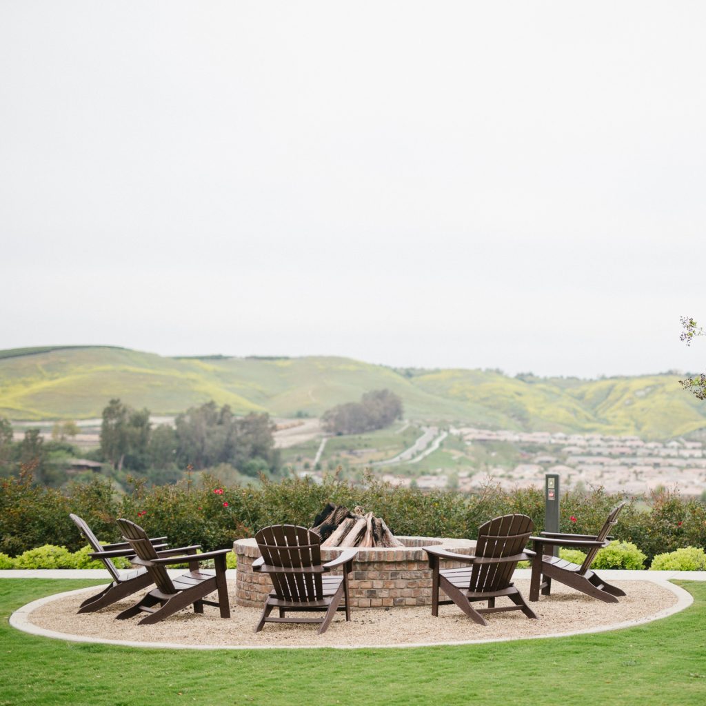 adirondack chairs around a fire pit
